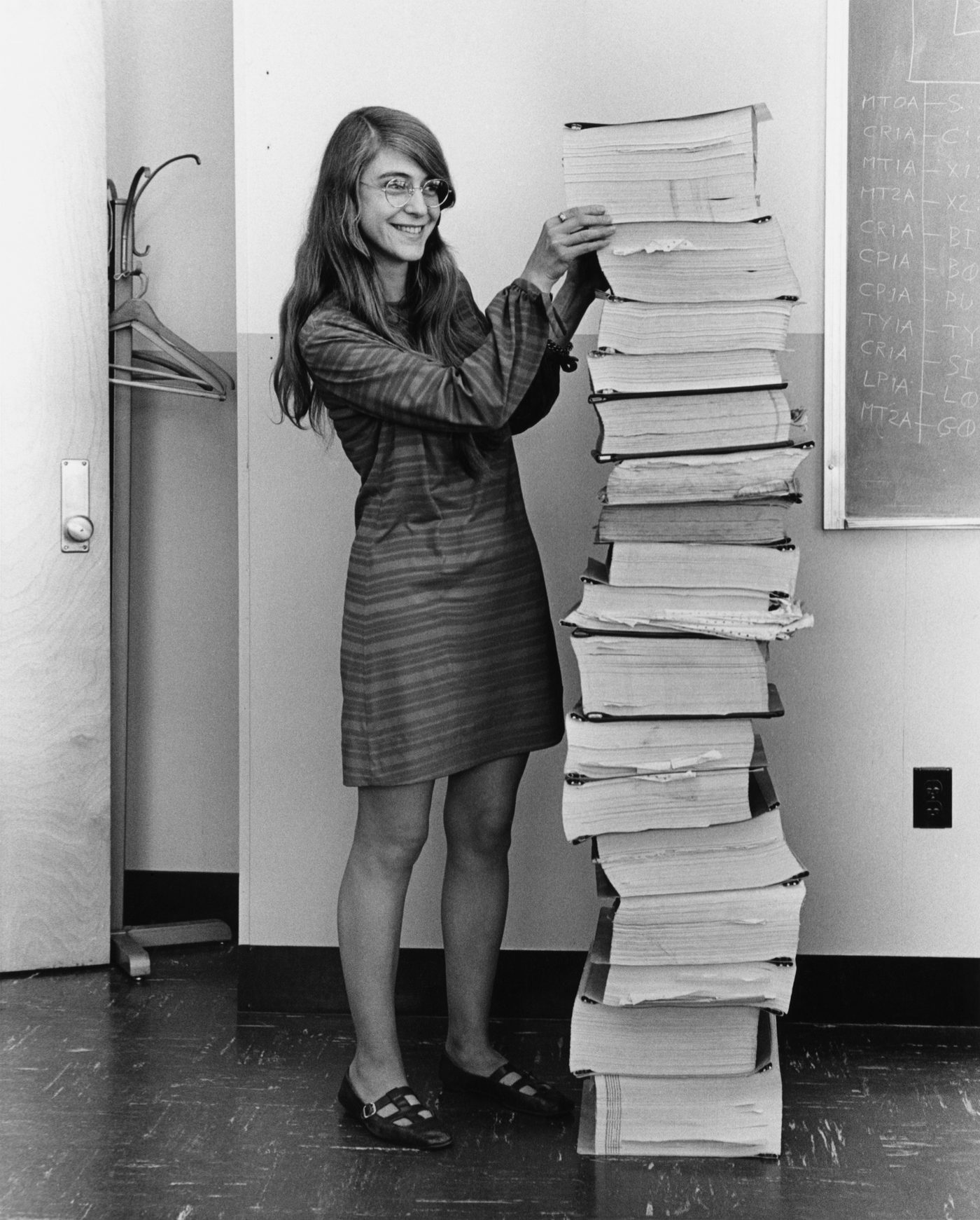 Figure 5 — Margaret Hamilton, who led the MIT Instrumentation Laboratory's Apollo software-engineering division, beside listings of the guidance software; this 1969 image became one of computing's …