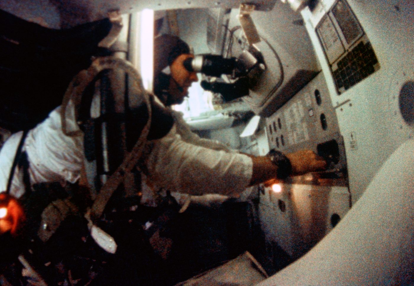 Figure 4 — An Apollo guidance and navigation station in flight: astronaut Jim Lovell at the optics of the Command Module's guidance system during Apollo 8, December 1968. The sextant and telescope …