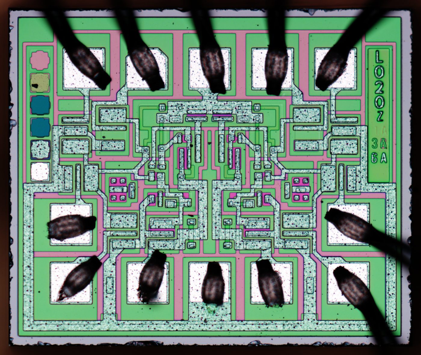 Figure 3 — Die-level view of a Fairchild integrated circuit. The AGC's logic was built from Fairchild RTL NOR-gate chips in flat-pack form. File:Fairchild-54LS20-HD.jpg by Mikhail Svarichevsky. Lic…