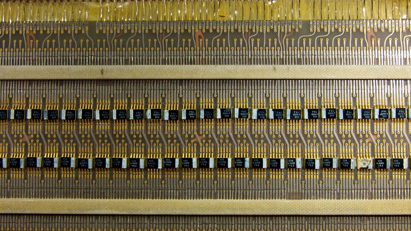 Figure 4 — An Apollo Guidance Computer logic module: a slab of interconnected flat-pack NOR-gate chips, potted for ruggedness. Thousands of these identical gates made up the machine. File:Apollo Gu…