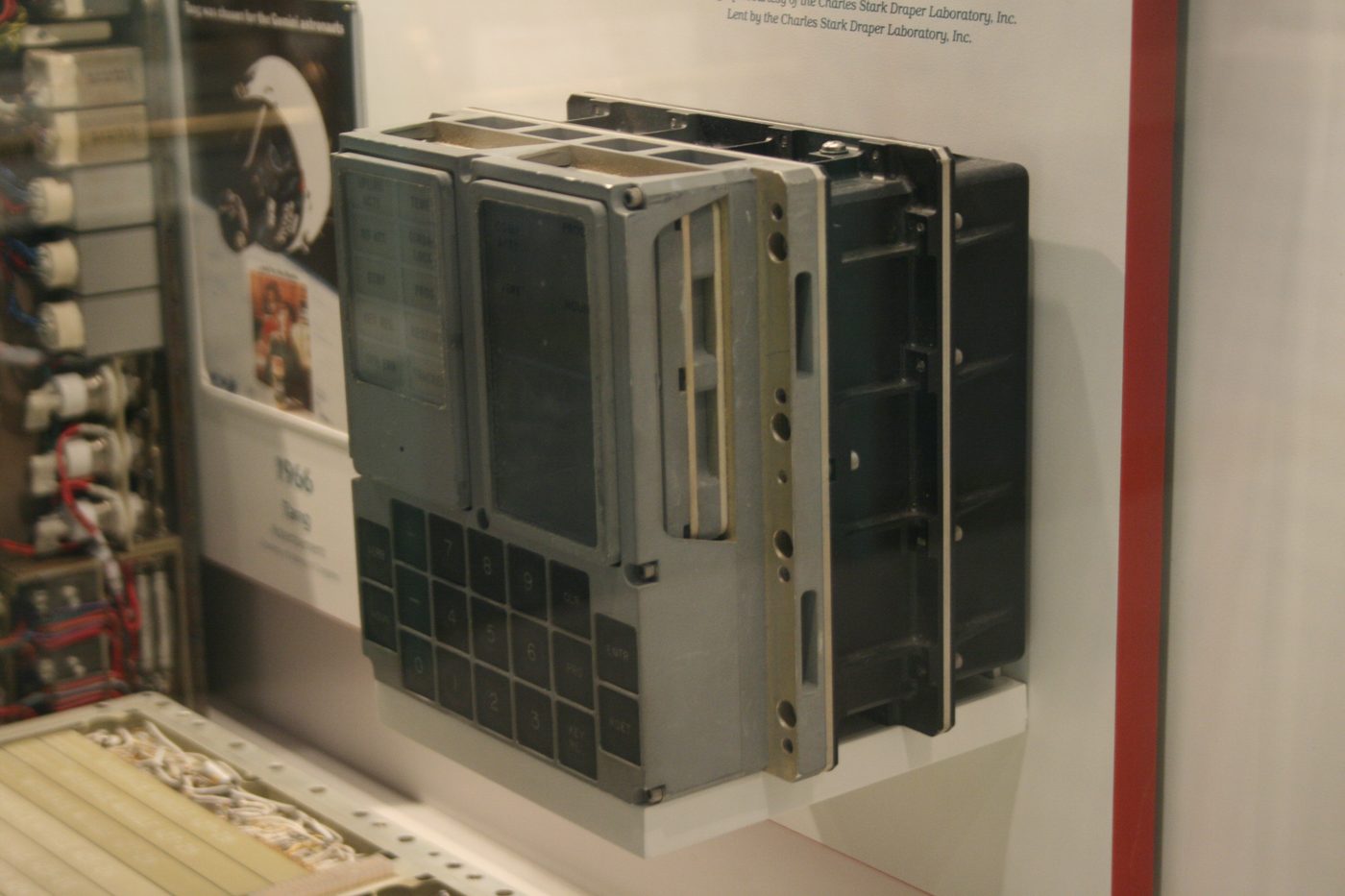 Figure 3 — An Apollo Guidance Computer alongside its DSKY, on museum display; the green numeric grid and lamp matrix are clearly visible. File:Apollo Guidance Computer (NASM).JPG by Tamorlan. Licen…