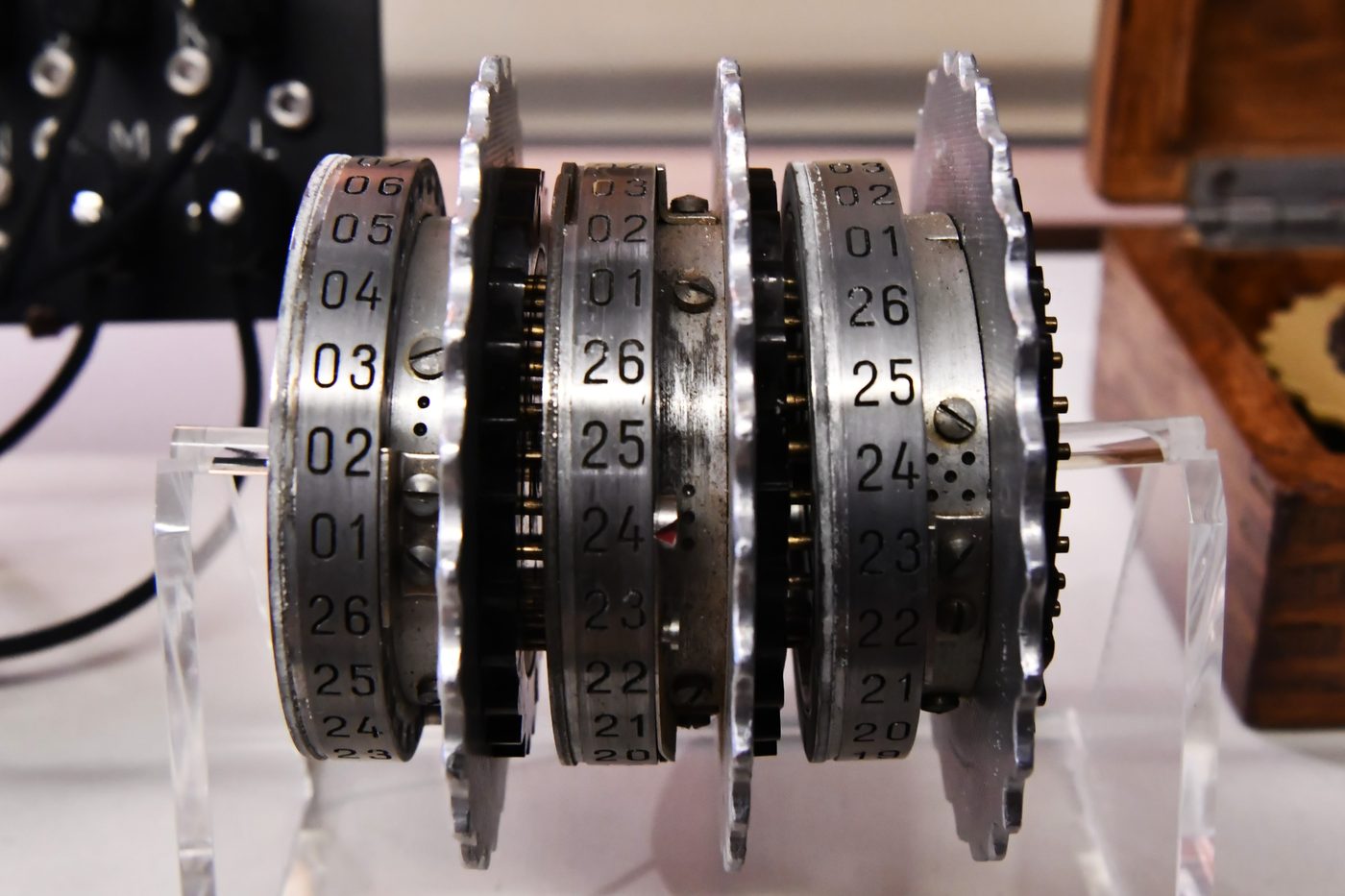 Figure 2 — A set of original Enigma rotors at Bletchley Park, Hut 11. Three are chosen from the box and placed in order, giving 5 × 4 × 3 = 60 possible arrangements. Photo: File:Bletchley Park, Hut…